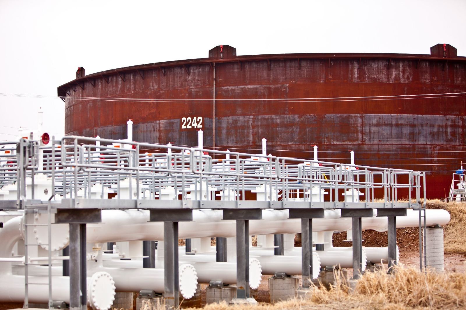 Crude oil storage tank and piping at an operating onshore facility